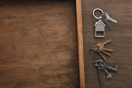 Set of different keys on wooden tray background. Safety and security concept, top view, copy space