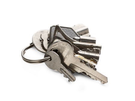 Bunch of new steel shiny keys isolated at white background. Collector, safety and security concept,...