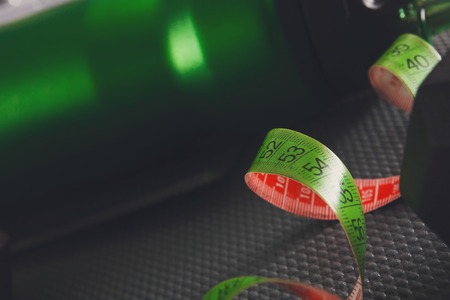 Green measuring tape closeup, copy space, blurred background. Weight loss, dieting, slimming conceptの写真素材