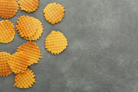 Belgium round waffles on gray background. Border of checkered cookies top view with copy space....