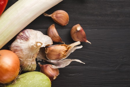 Garlic cloves on wooden dark background with copy space. Fresh organic cooking ingredientsの写真素材