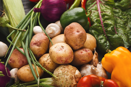 Heap of fresh vegetables background. Potatoes, spring onion, pepper, mushrooms. Grocery store conceptの写真素材