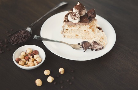 Meringue cake with hazelnuts and buttercream. Traditional ukrainian dessert Kiev cake, delicious sweet treat, copy space, top viewの写真素材