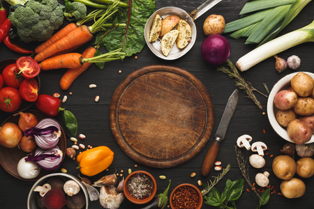Fresh organic vegetables and wooden board with copy space background. Healthy natural food. Tomato, lettuce, carrot, pepper, potato and other cooking ingredients, top viewの写真素材