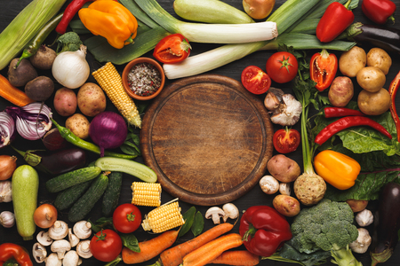 Fresh organic vegetables and wooden board with copy space background. Healthy natural food. Tomato, lettuce, carrot, pepper, potato and other cooking ingredients top viewの写真素材
