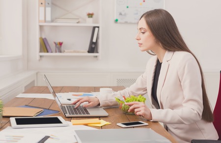 Business woman working on laptop at office. Businesswoman typing something on computer while sitting at her working place, copy spaceの写真素材