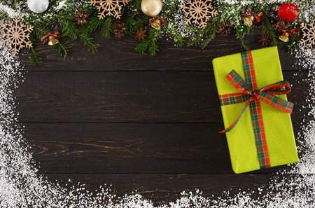 Christmas background with decorations, green dotted gift box and garland frame concept , top view on...