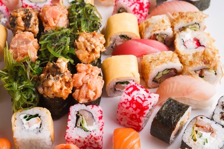 Sushi and rolls pattern background, restaurant delivery closeup. Salmon, unagi, california and other healthy meals. Traditional japanese cuisine backdropの写真素材