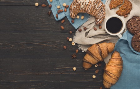 French croissants and coffee background. Tasty french breakfast with variety of homemade cookies,...
