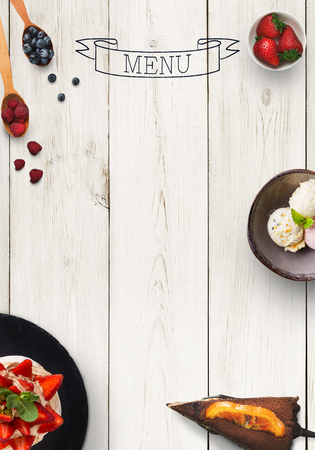Design concept for restaurant dessert menu mockup. White rustic wooden board with white inscription and sweet snacks, top view, copy space for textの写真素材