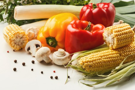 Heap of fresh organic tasty vegetables background. Healthy natural food on white table, cooking ingredients, organic vegetarian harvestの写真素材