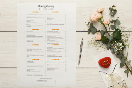 Wedding background with checklist. Paper planner and wedding rings on white wooden table with tender bridal bouquet, top viewの写真素材