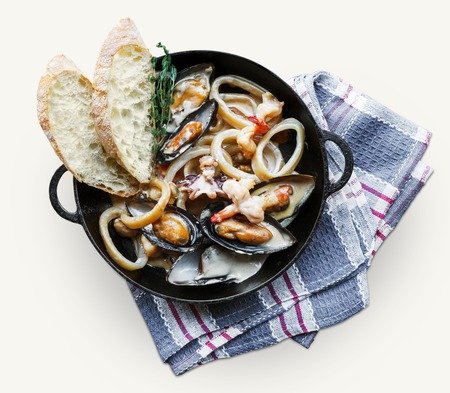 Seafood stew in saucepan isolated on white background. Authentic italian restaurant cuisine, healthy...