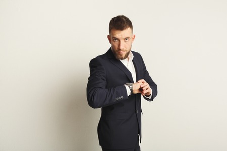 Handsome young caucasian businessman studio shot on white background. Confident serious man in...