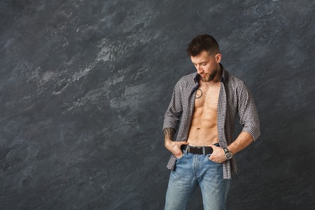 Handsome man with athletic body posing in studio.
