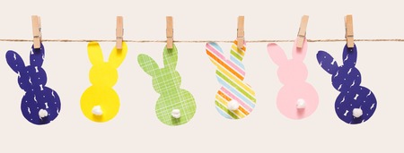 Easter bunny craft paper garland isolated on white background. DIY holiday handicraft decoration of colorful rabbits. Top view, cutoutの写真素材