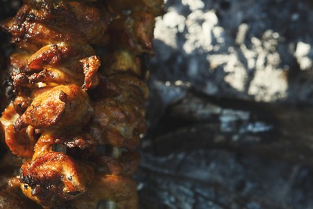 Street fast food festival. Cooking raw kebab closeup. BBQ fresh beef chop slices. Traditional eastern dish, shish kebab. Grill on charcoal and flame, picnic.の写真素材