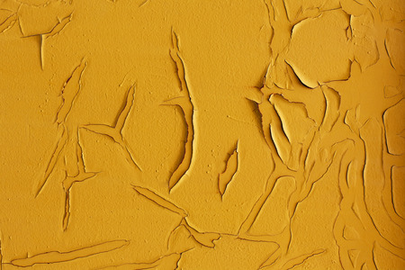 Closeup of old yellow painted wall. Grunge background with cracks, abstract rustic backdrop, macroの写真素材