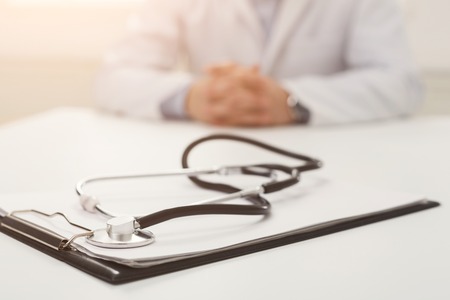 Stethoscope on notebook, selective focus, closeup. Doctor waiting for patient in hospital, healthcare and medical conceptの写真素材