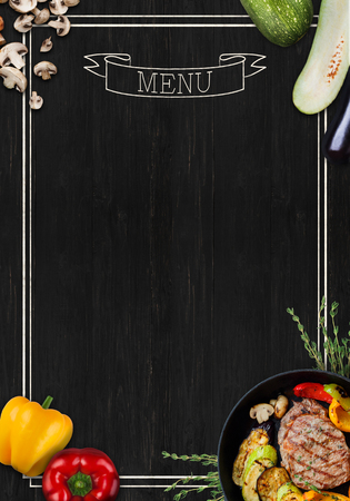 Design concept for restaurant meat and grill menu mockup. Black rustic chalkboard with white inscription and frame, top view, copy space for text and logoの写真素材