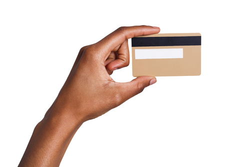 Closeup of black female hand holding plastic credit card , woman showing blank business card on white isolated studio background, copy space, cutoutの写真素材