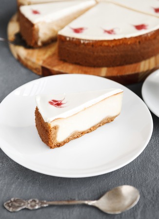 New York cheesecake on dark background. Delicious dessert with slice, traditional sweet treat, copy spaceの写真素材