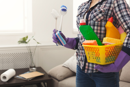 Unrecognizable woman with cleaning equipment ready to clean house. Professional cleaning service concept, copy spaceの写真素材