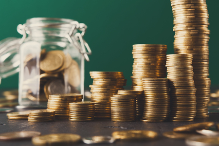 Coins in glass jar, copy space. Money box, saving money for dream, pension, vacation. Financial...