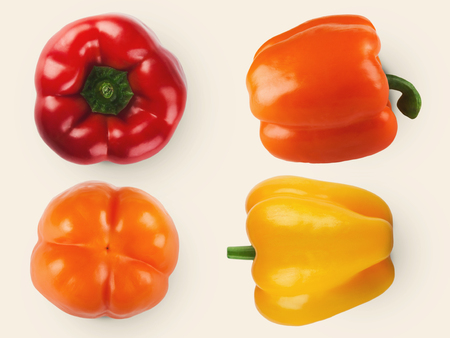 Sweet bell peppers of different color isolated on white background. Set of red, orange and yellow vegetables, top view, copy spaceの写真素材