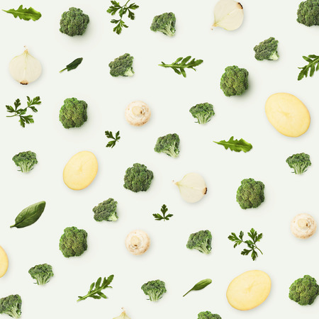 Pattern of vegetables and greens. Food background, top view. Composition of broccoli, onions, mushrooms and potatoes isolated on white background.の写真素材