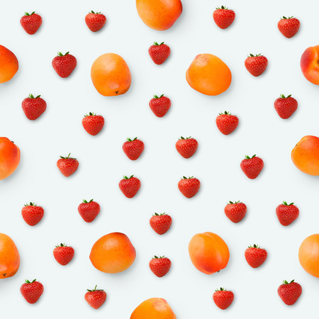 Pattern with strawberries and apricots. Berries isolated on white, top view. Juicy food backgroundの写真素材