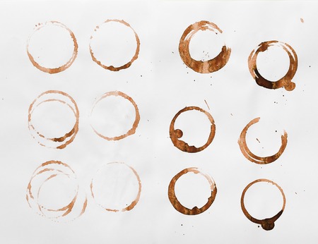 Set of coffee cup stains isolated on white background. Dry rings of bracing beverage. Collection of brown spots for grunge designの写真素材