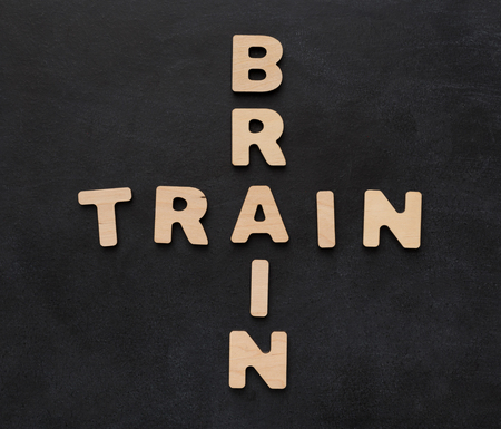 Brain train phrase spelled with wooden letters on black background. Inspiration, creativity, imagination, brainstorm concept, top view, copy spaceの写真素材