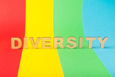 Diversity word spelled with wooden letters on colorful background, copy spaceの写真素材