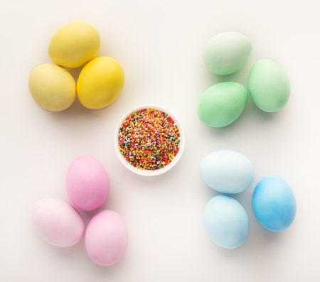 Clorful easter chicken eggs on white isolated background. Top view on stylish composition with...