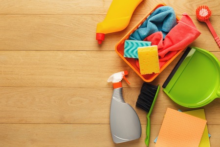 House cleaning products and supplies on wooden background, top view. Spring cleaning and household concept. Mockup for advertisement with copy spaceの写真素材