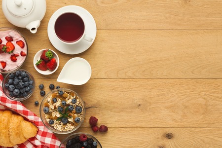 Tasty breakfast with light greek yogurt, muesli, fresh organic berries and black coffee. Low fat...