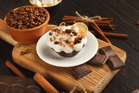 Tasty dessert background. Cake piece, chocolate bars, refined sugar, coffee beans, cinnamon and dry...