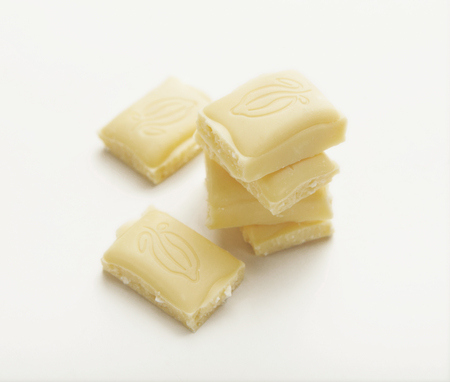 White chocolate bar pieces isolated on white background, cutoutの写真素材