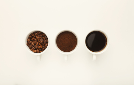 Assortment of coffee in cups. Whole beans, ground coffee and freshly brewed americano isolated on...