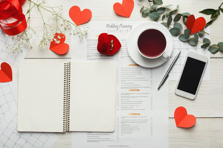 Wedding to do list top view. Present boxes, calendar for marriage planning and various bridal stuff on white rustic table. Memmorable date organization backgroundの写真素材