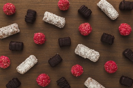 Assortment of chocolate candies on wooden table. Confectionery sweet background, top viewの写真素材