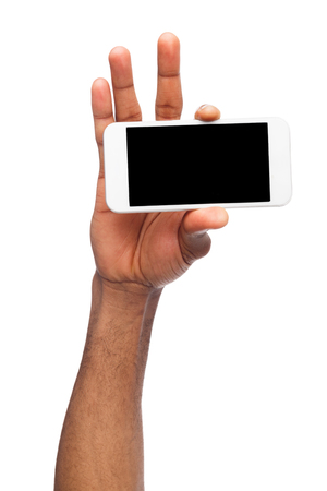 African-american male hand holding mobile smartphone with blank screen, isolated on white background. Copy space for advertisement of mobile app, mockupの写真素材