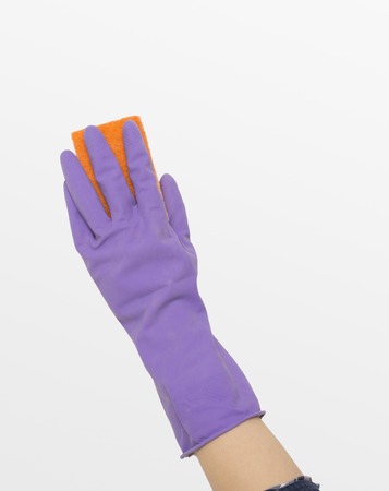 Woman's hand in rubber protective glove wiping white wall from dust with dry rag. CLeaning service...