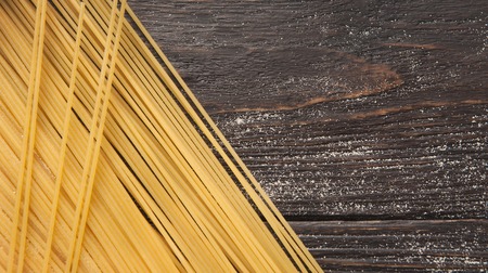 Raw italian spaghetti on wooden background with copy space, top viewの写真素材