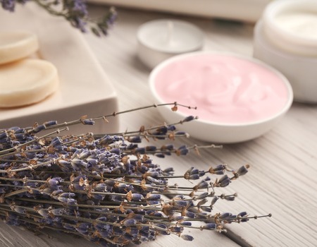 Assortment of face creams with lavender essential oil and spa products on white wooden background. Skincare and spa conceptの写真素材