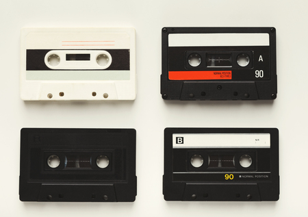 Retro audio cassette tapes isolated on white background. Top view on vintage media device, copy space, flat layの写真素材