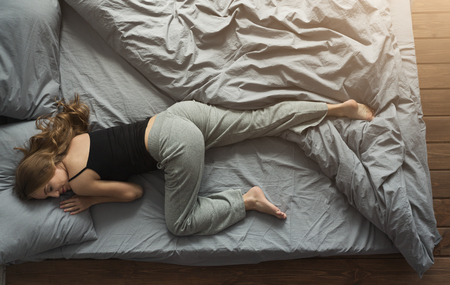 Young woman sleeping in bed at home, top viewの写真素材