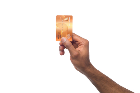 Banking services. Black male hand holding plastic credit card on white isolated studio background, copy space, cutoutの写真素材