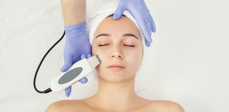 Rejuvenating facial treatment. Model getting lifting therapy massage in a beauty SPA salon....